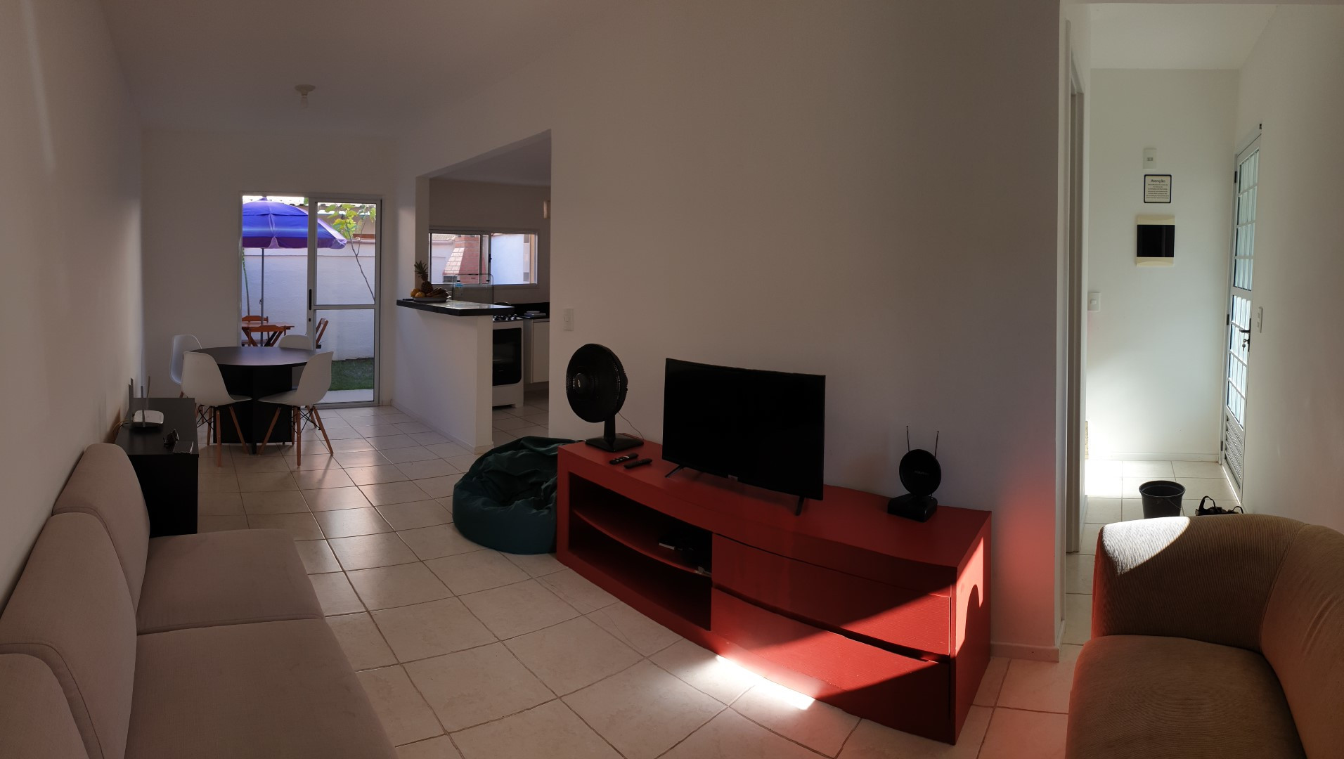 Panorama view of the hallway and the living room.